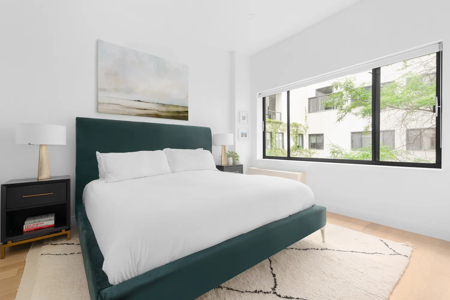 a bedroom with a bed and a large window