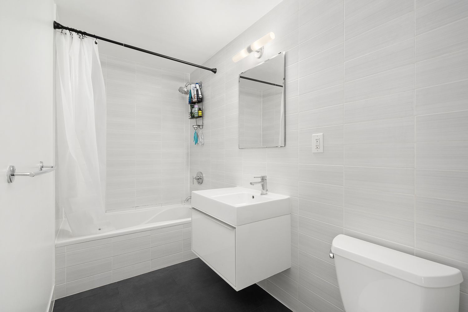 51 East 128th Street, Unit 1C Manhattan, NY 10035 - Photo 5 of 9 a bathroom with a sink a toilet and shower