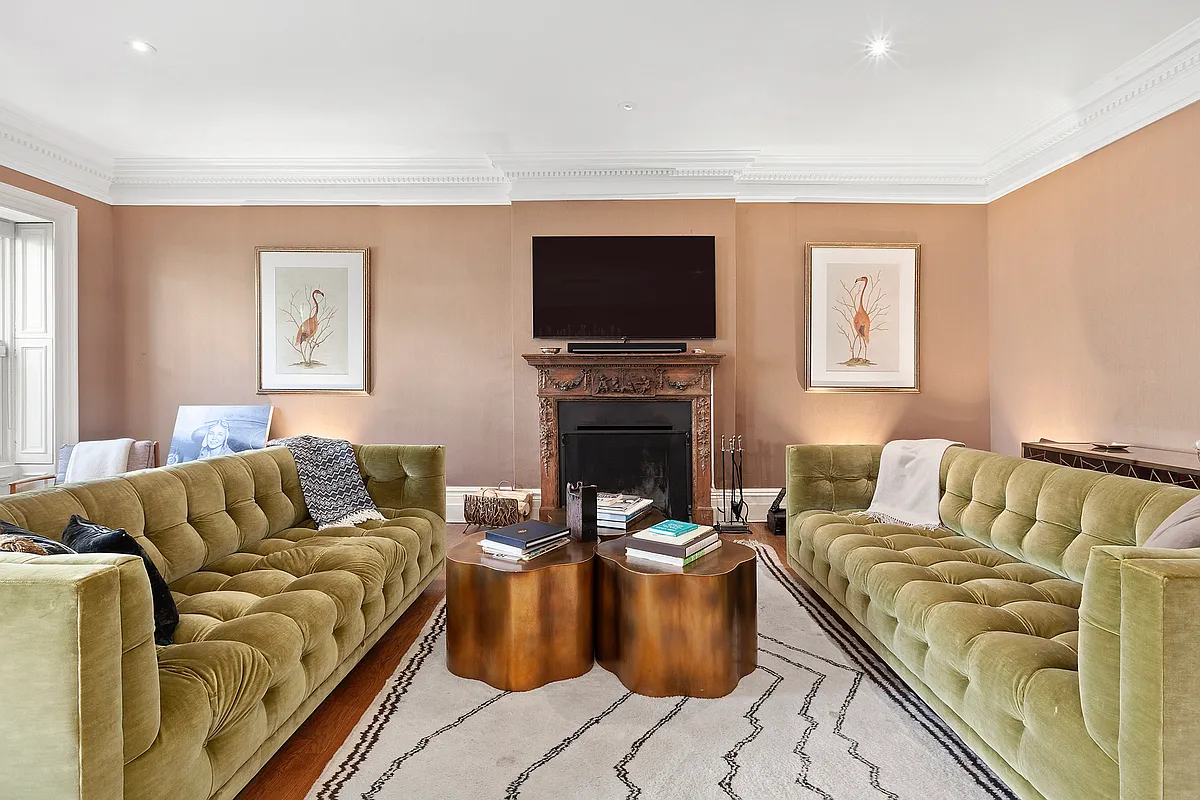 16 East 74th Street, Unit 4/5 Manhattan, NY 10021 - Photo 3 of 13 a living room with furniture a flat screen tv and a fireplace