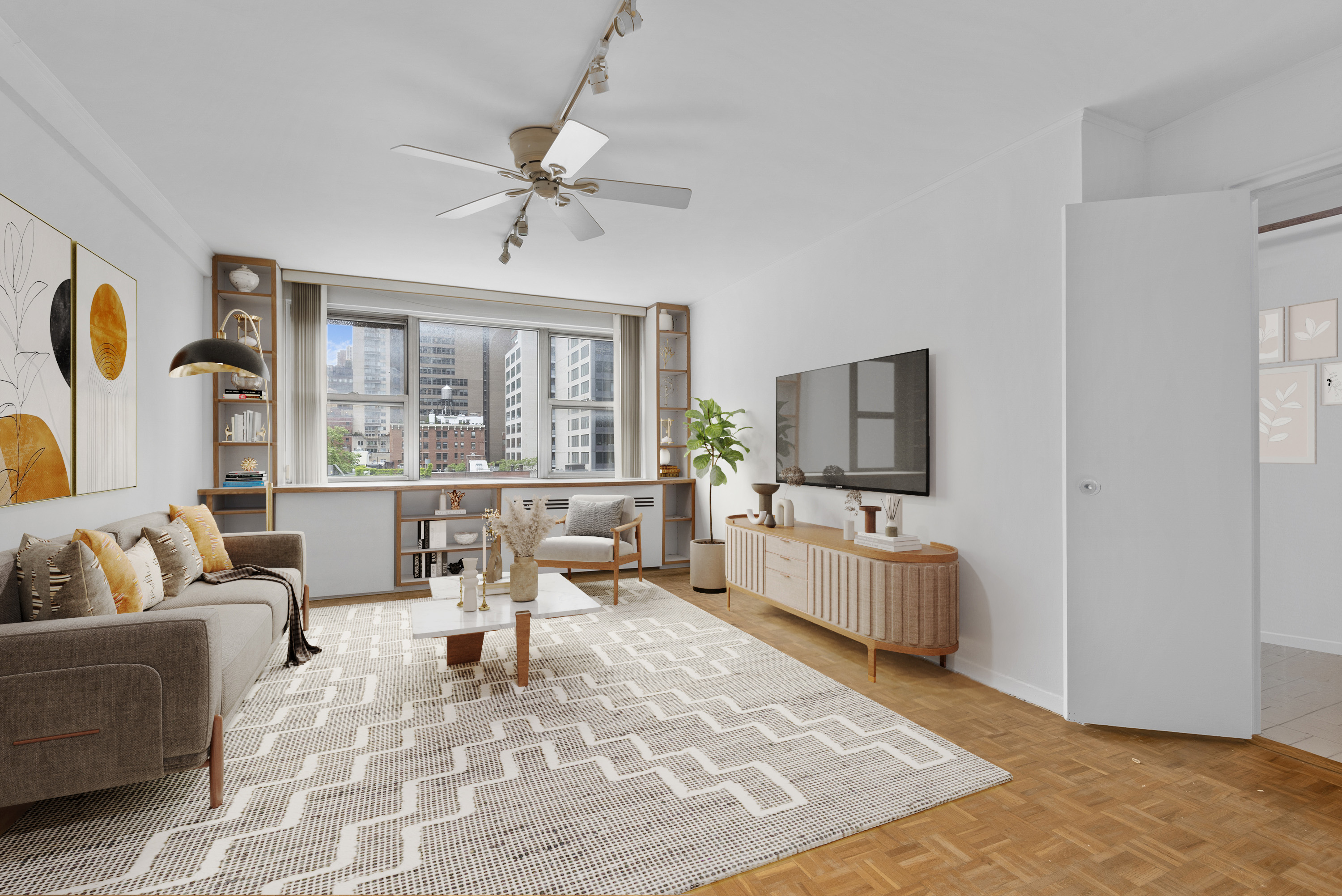 221 East 50th Street, Unit 8B Manhattan, NY 10022 - Photo 1 of 9 a living room with furniture and a flat screen tv
