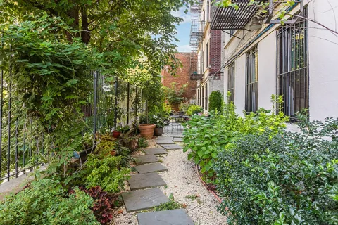 a view of a pathway both side of the house