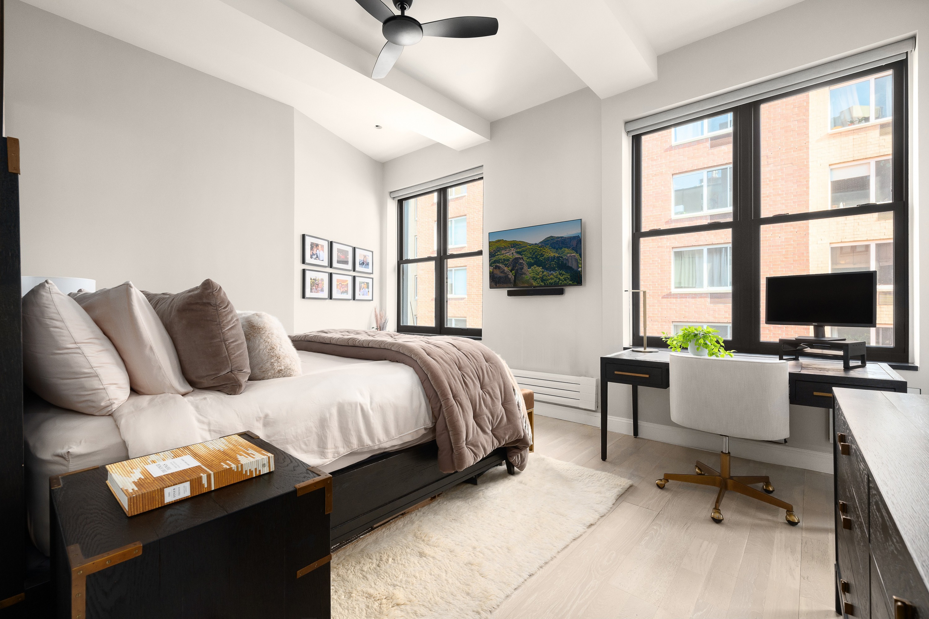 521 West 47th Street, Unit 3B Manhattan, NY 10036 - Photo 12 of 15 a bedroom with a bed and a flat screen tv