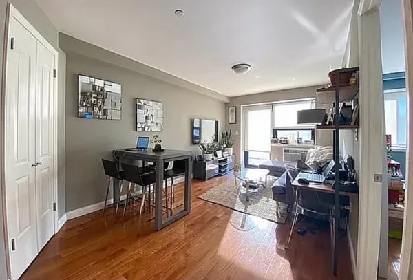 a view of a dining room with furniture and wooden floor