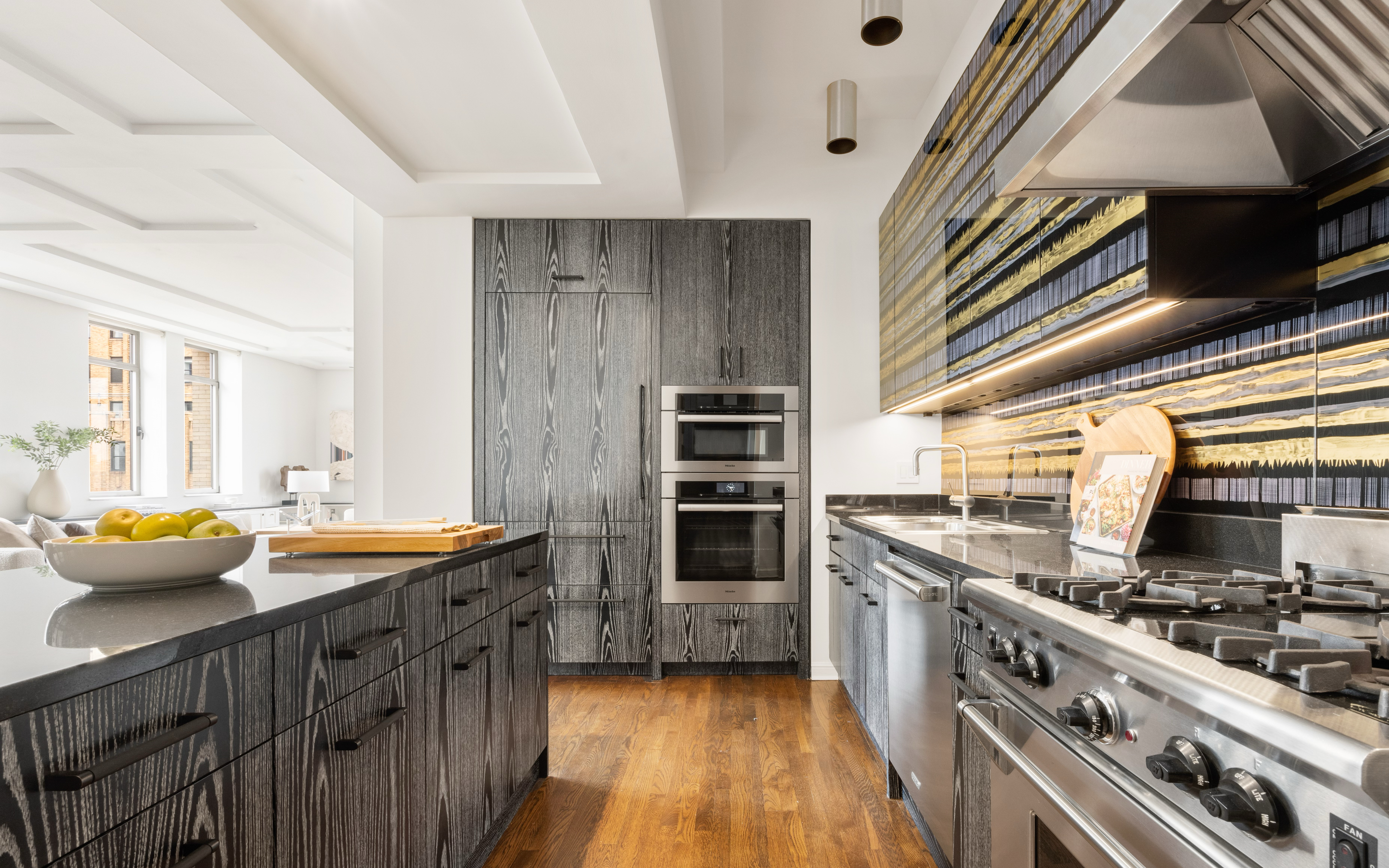 252 7th Avenue, Unit 17I Manhattan, NY 10001 - Photo 6 of 17 a kitchen with stainless steel appliances granite countertop a stove and a sink