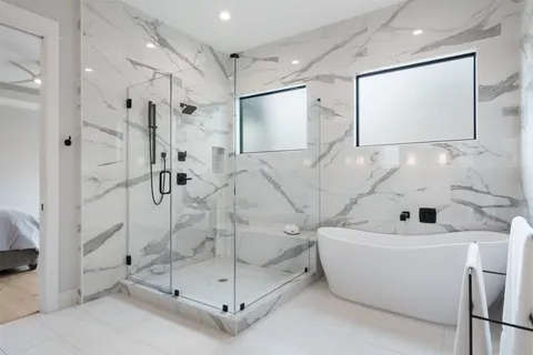 a bathroom with a bathtub and shower