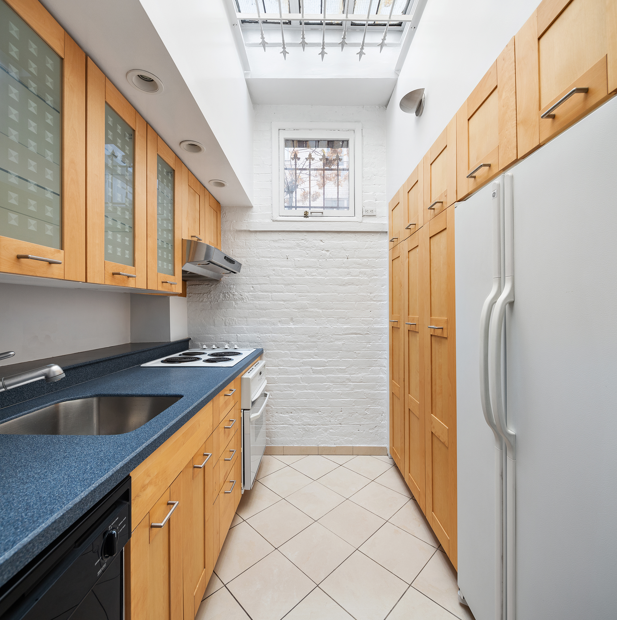 7 East 74th Street, Unit PH Manhattan, NY 10021 - Photo 5 of 10 a kitchen with stainless steel appliances granite countertop a refrigerator and a sink