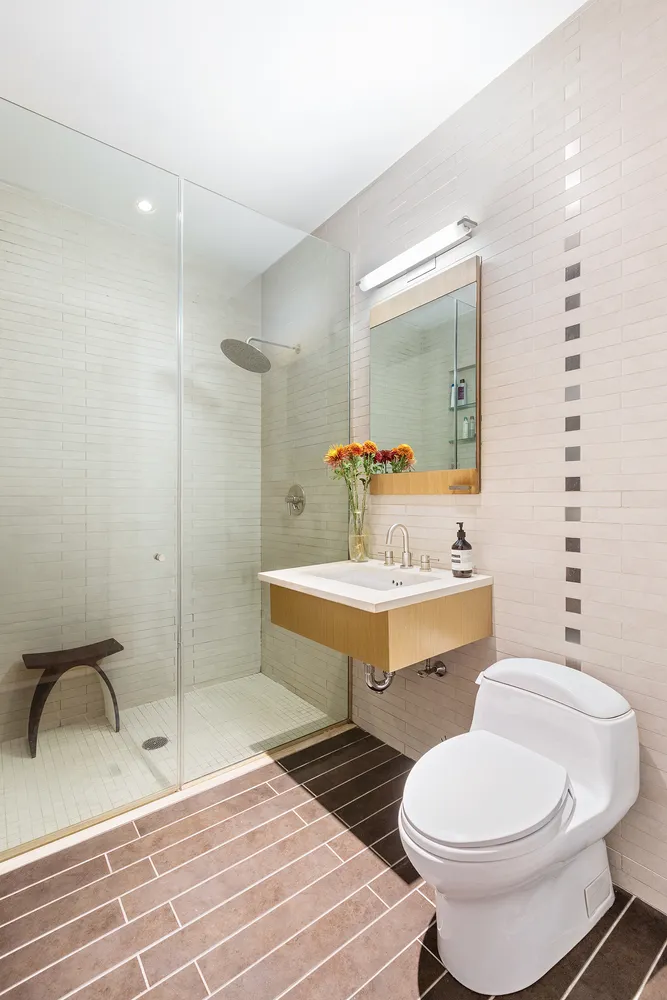 a bathroom with a sink toilet mirror and vanity