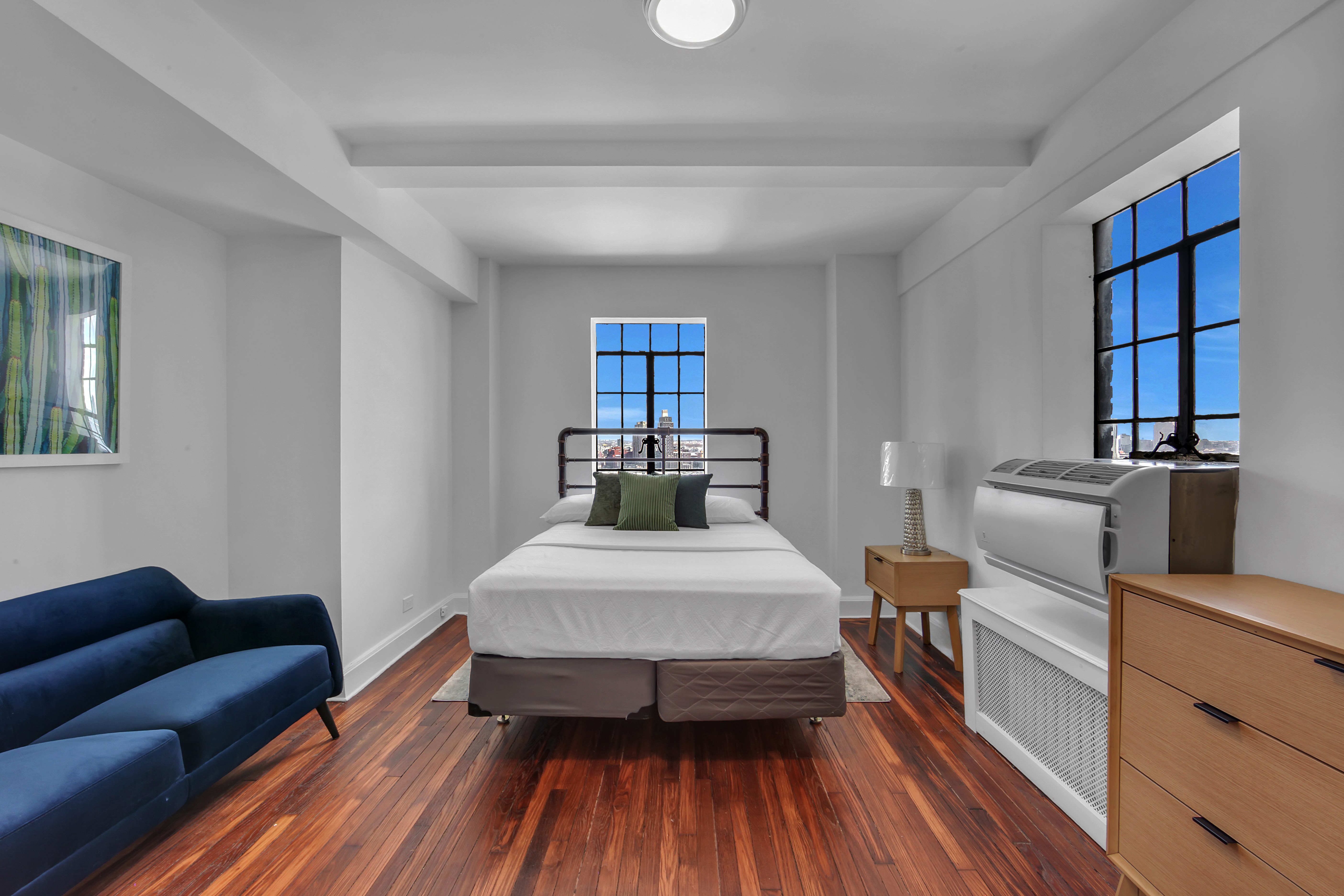 5 Tudor City Place, Unit 1536 Manhattan, NY 10017 - Photo 1 of 21 a bed room with a bed and a chair