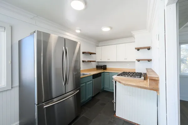 a kitchen with stainless steel appliances a refrigerator sink and stove