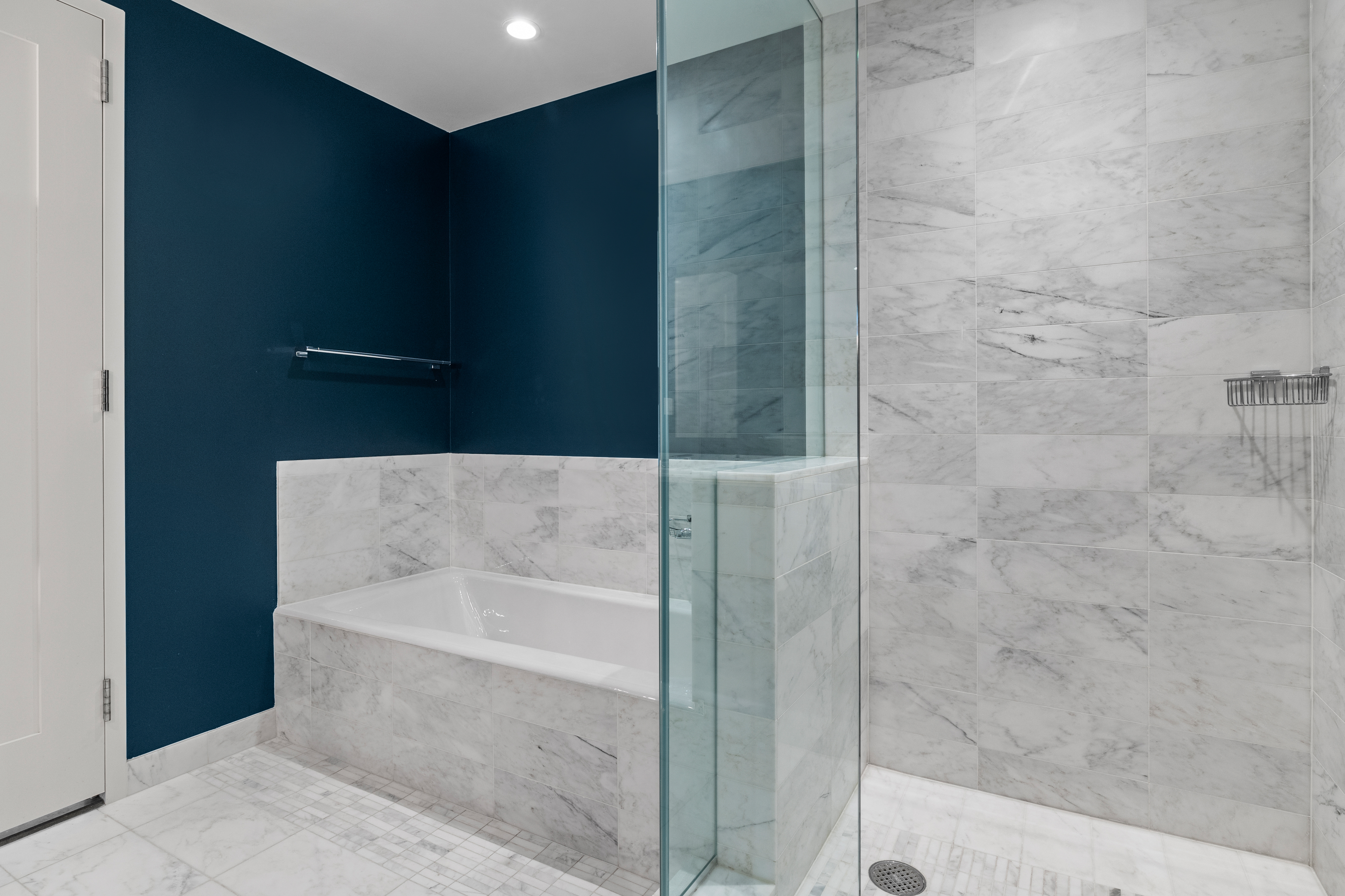 580 Washington Street, Unit PH5 Boston, MA 02111 - Photo 8 of 12 a bathroom with a bathtub and shower