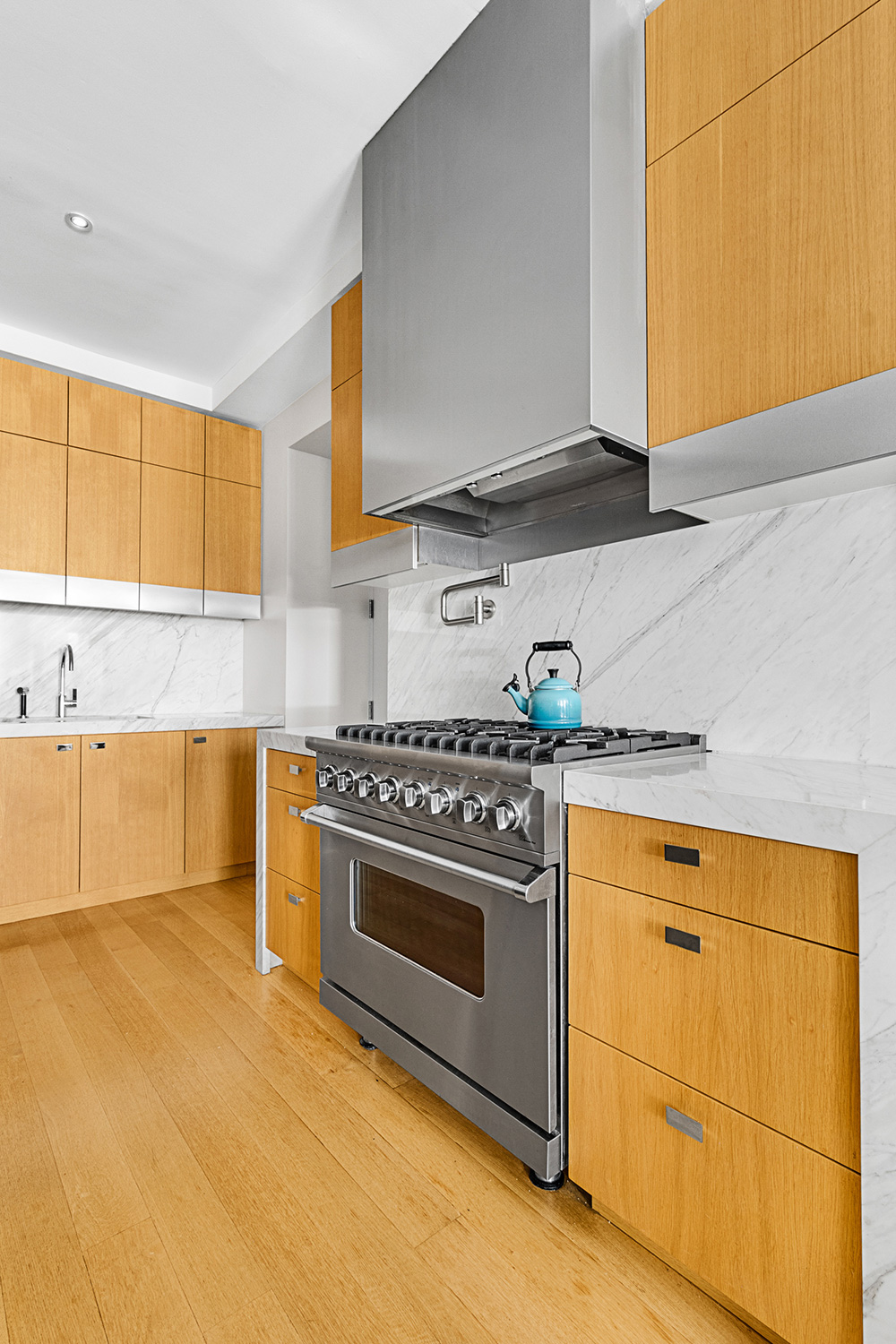 15 Hubert Street, Unit 2C Manhattan, NY 10013 - Photo 4 of 15 a kitchen with stainless steel appliances granite countertop a stove a sink and a microwave