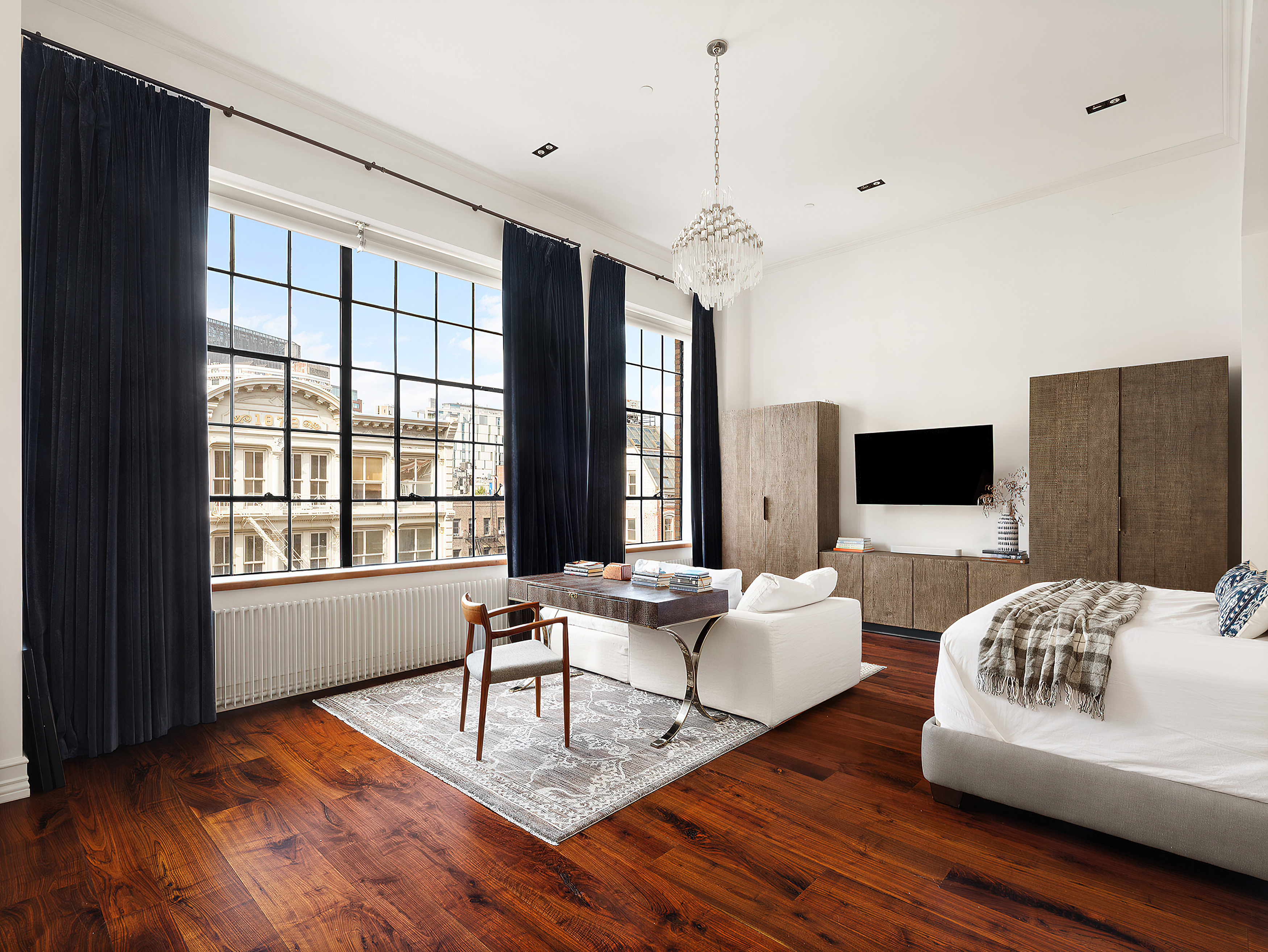 73 Wooster Street, Unit PHA Manhattan, NY 10012 - Photo 11 of 25 a living room with furniture and a flat screen tv