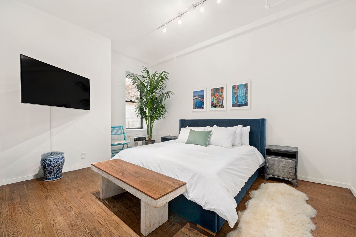 a bedroom with a bed and a flat screen tv