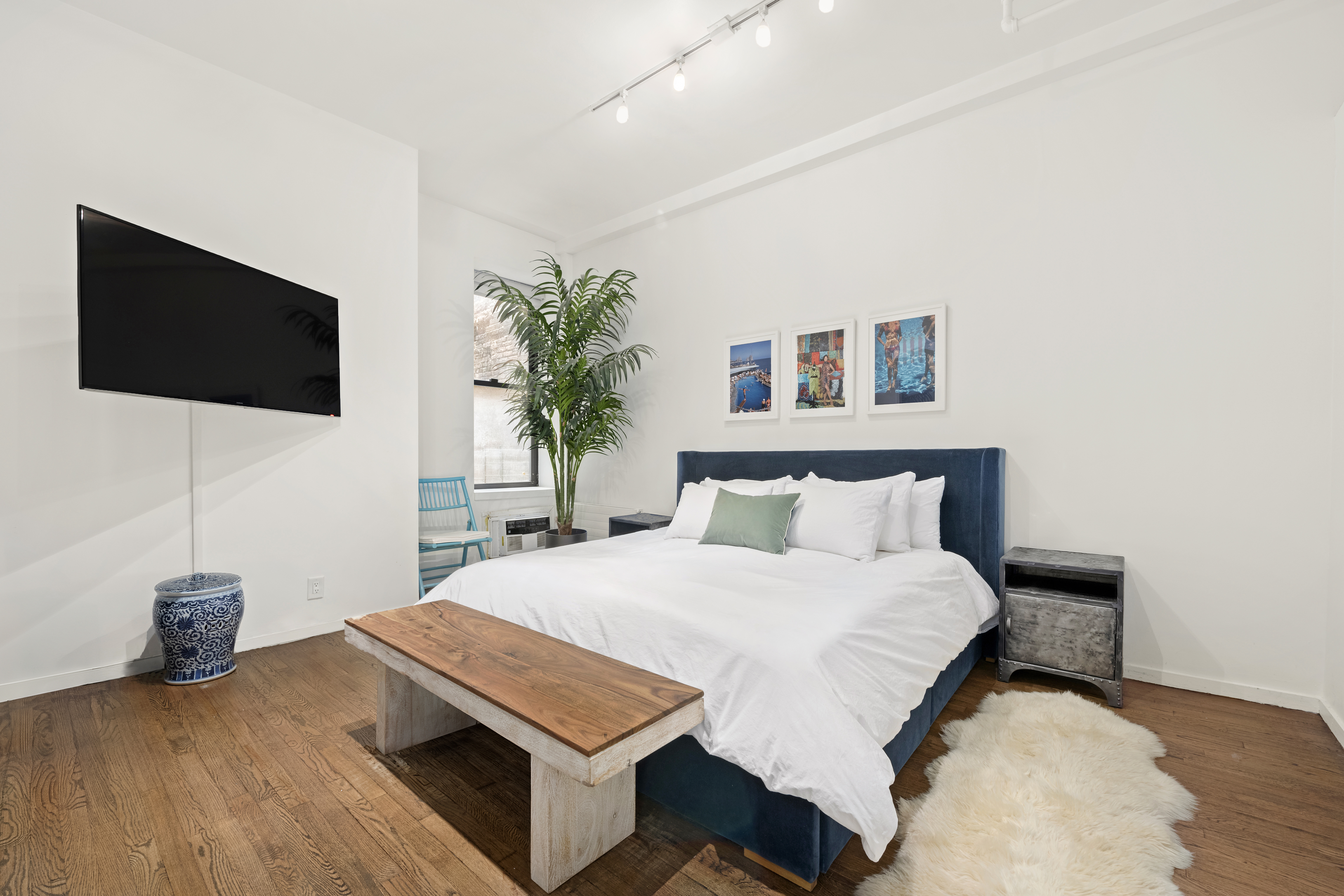 120 West 18th Street, Unit 2A Manhattan, NY 10011 - Photo 9 of 14 a bedroom with a bed and a flat screen tv