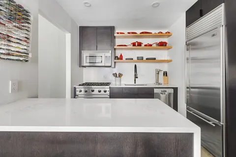 a large white bed in a kitchen