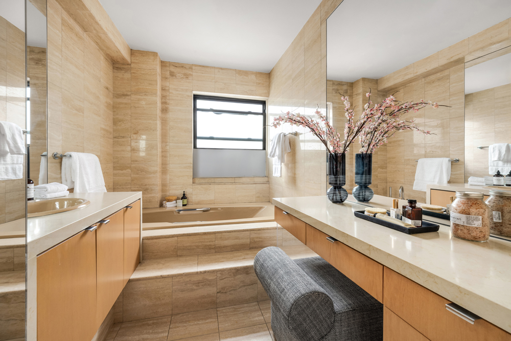 510 East 86th Street, Unit 17C Manhattan, NY 10028 - Photo 22 of 31 a bathroom with a tub sink and mirror