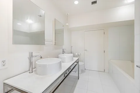 a bathroom with a sink a toilet and bathtub