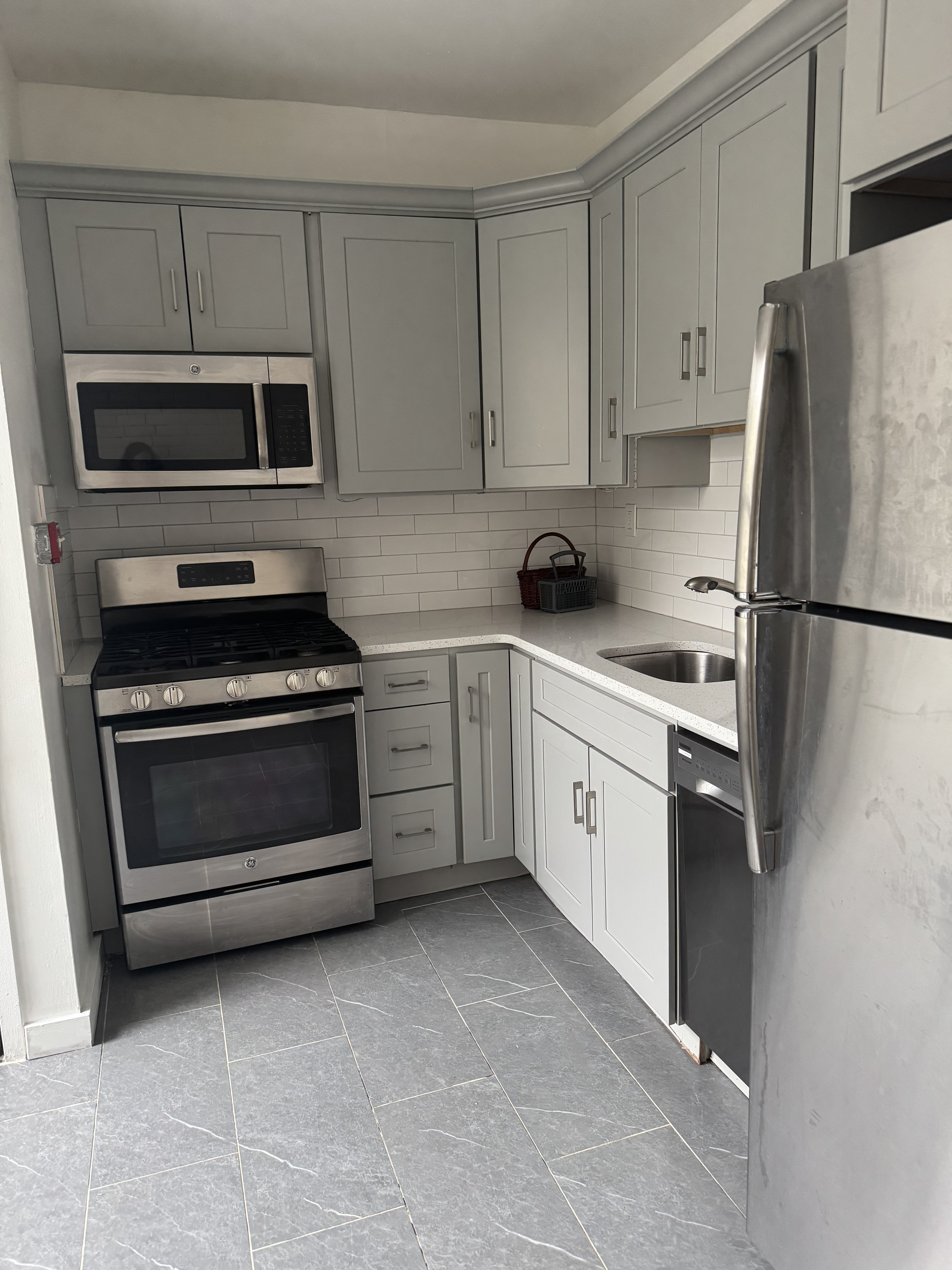 149 Sterling Street, Unit 4D Brooklyn, NY 11225 - Photo 1 of 7 a kitchen with white cabinets and white appliances