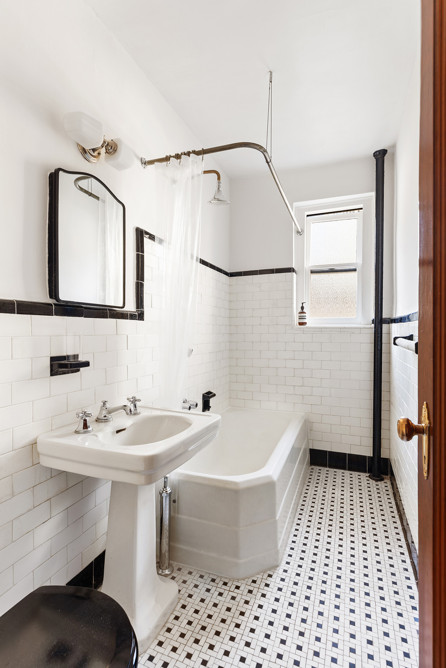 135 East 39th Street, Unit 5E Manhattan, NY 10016 - Photo 7 of 13 a bathroom with a sink a toilet and shower
