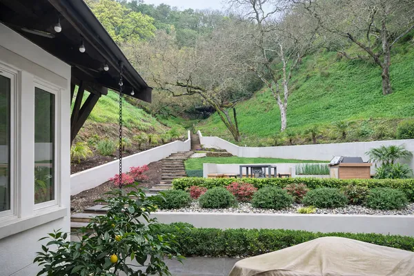 a view of a patio with couches under an umbrella
