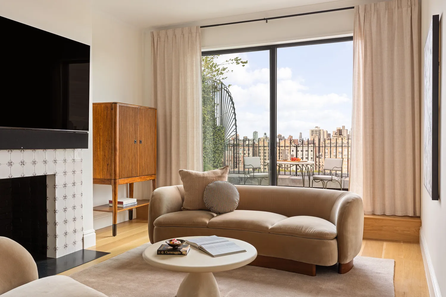 a living room with furniture a fireplace and a flat screen tv