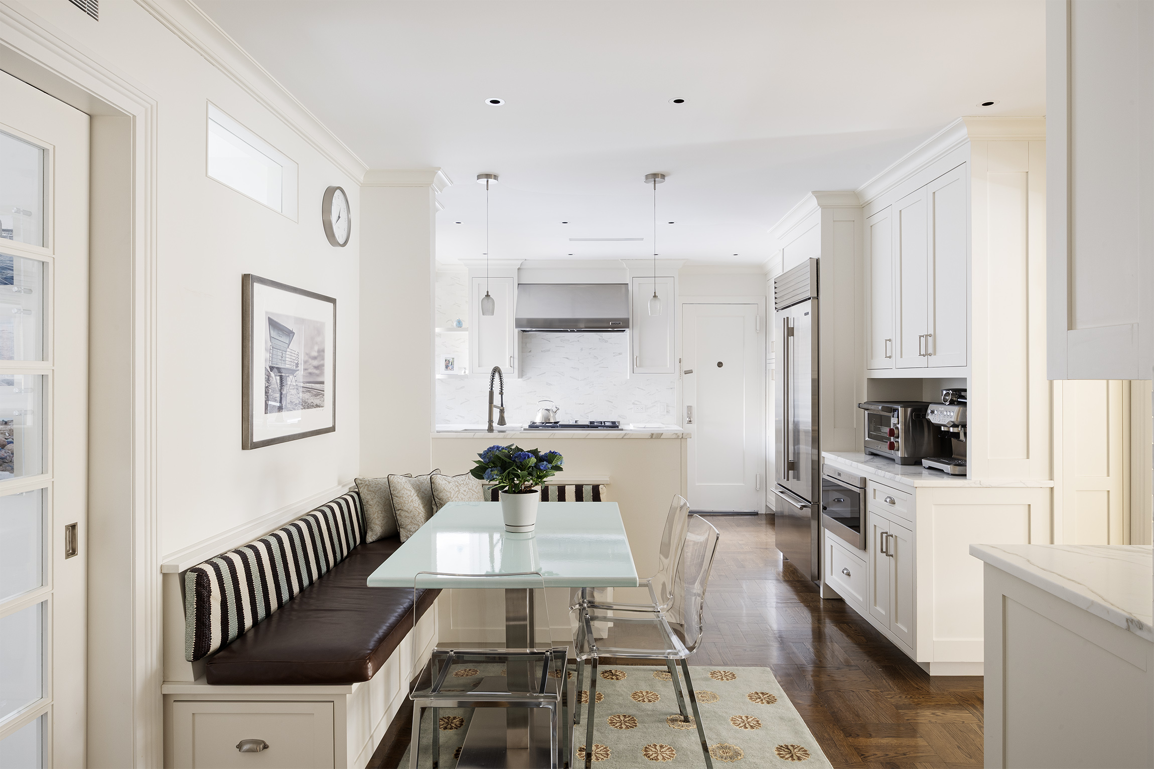 a view of a kitchen with furniture and wooden floor