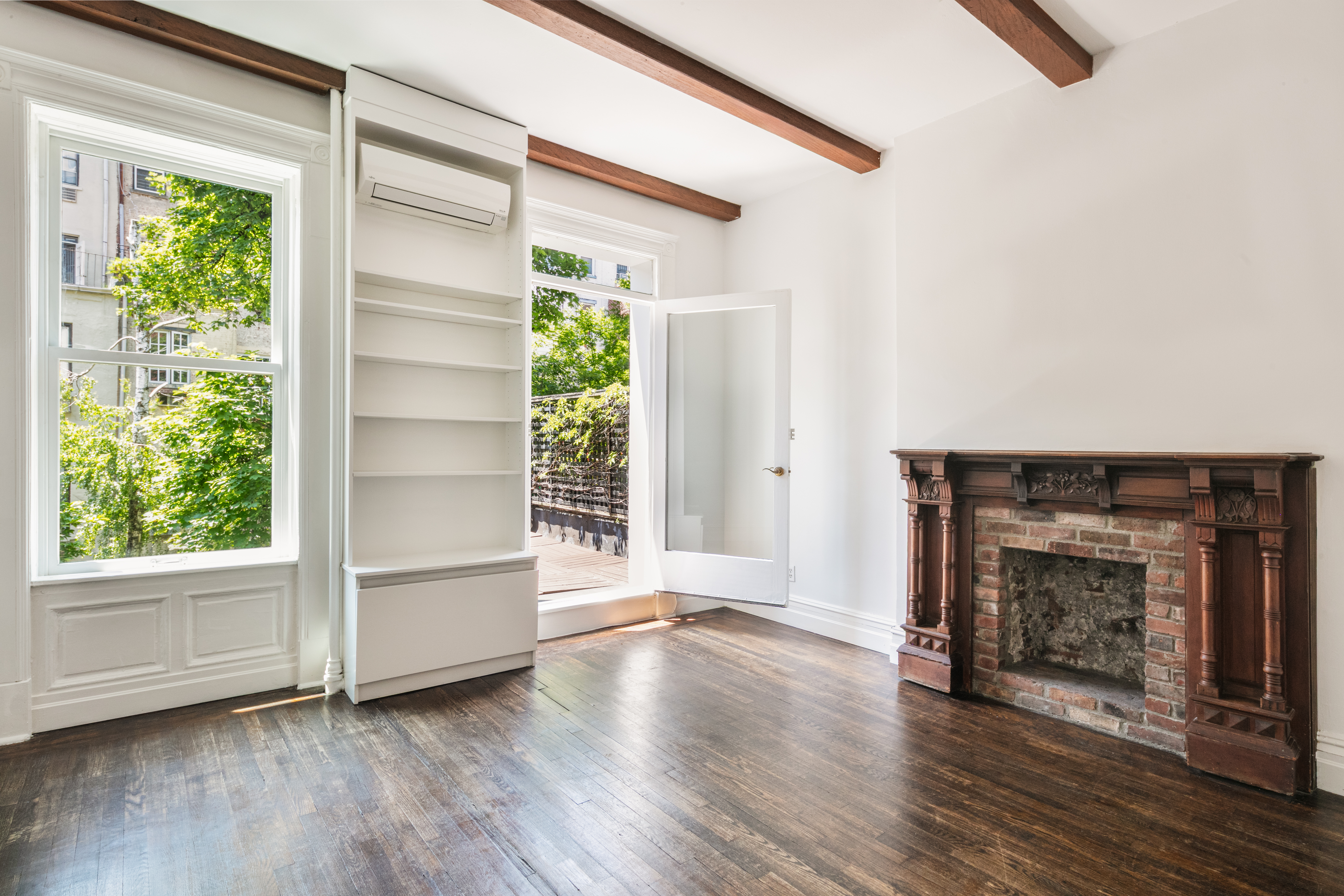 112 West 78th Street, Unit PARLOR Manhattan, NY 10024 - Photo 20 of 37 an empty room with wooden floor fire place and windows