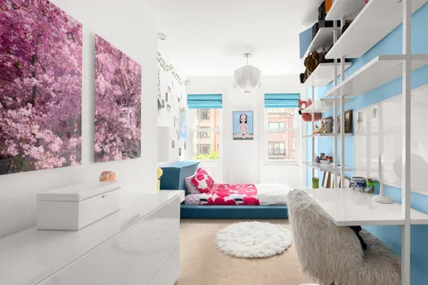 a bedroom with furniture and a large window