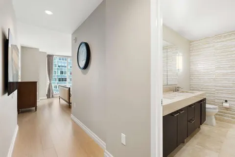 a bathroom with a granite countertop sink a toilet a vanity and mirror