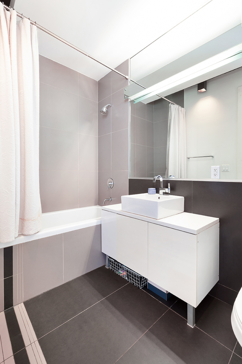 15 Roebling Street, Unit 2A Brooklyn, NY 11211 - Photo 7 of 8 a bathroom with a sink and a mirror