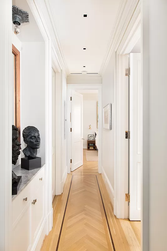 390 West End Avenue, Unit 7DS Manhattan, NY 10024 - Photo 13 of 31 a hallway with white cabinets and black appliances