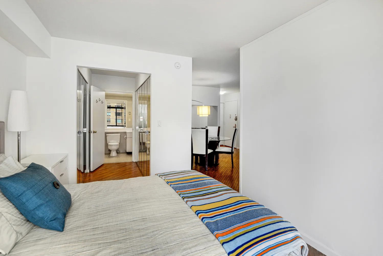 a bedroom with a bed and a mirror