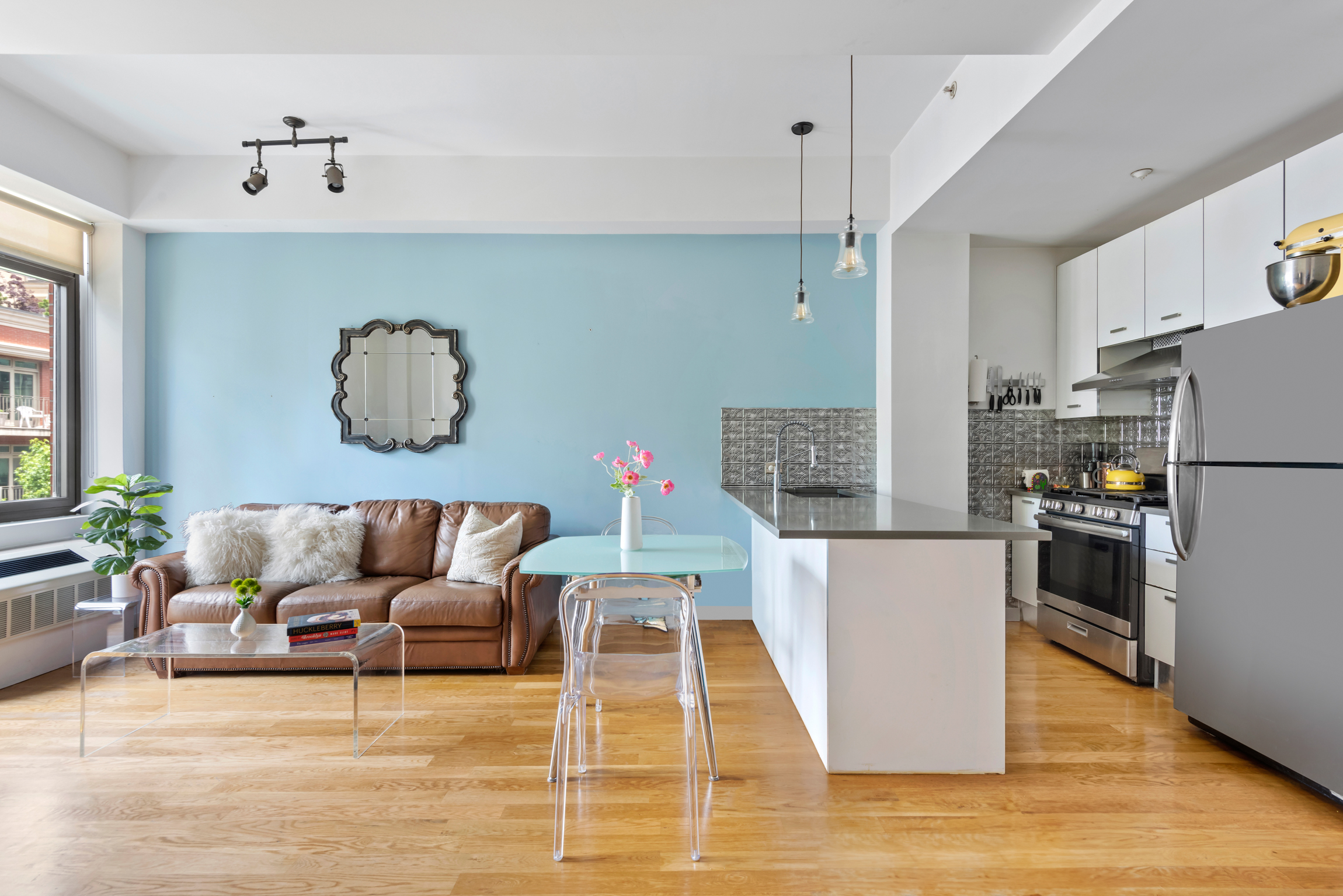 a living room with furniture and kitchen view