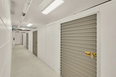 a view of water with boats and trees in the background