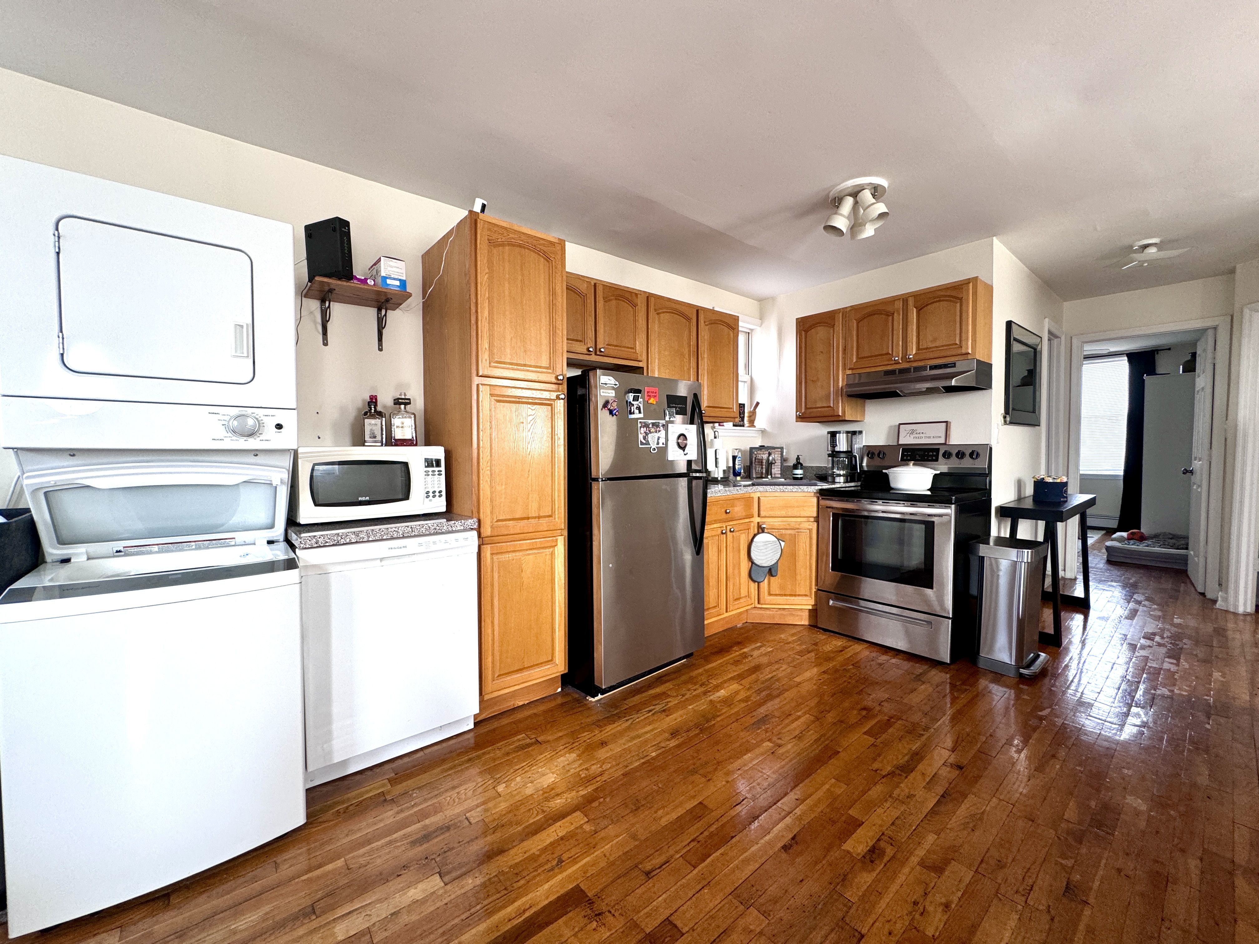 4 Gotham Avenue, Unit 2 Brooklyn, NY 11229 - Photo 2 of 6 a kitchen with stainless steel appliances a refrigerator a stove top oven a sink dishwasher and wooden cabinets with wooden floor
