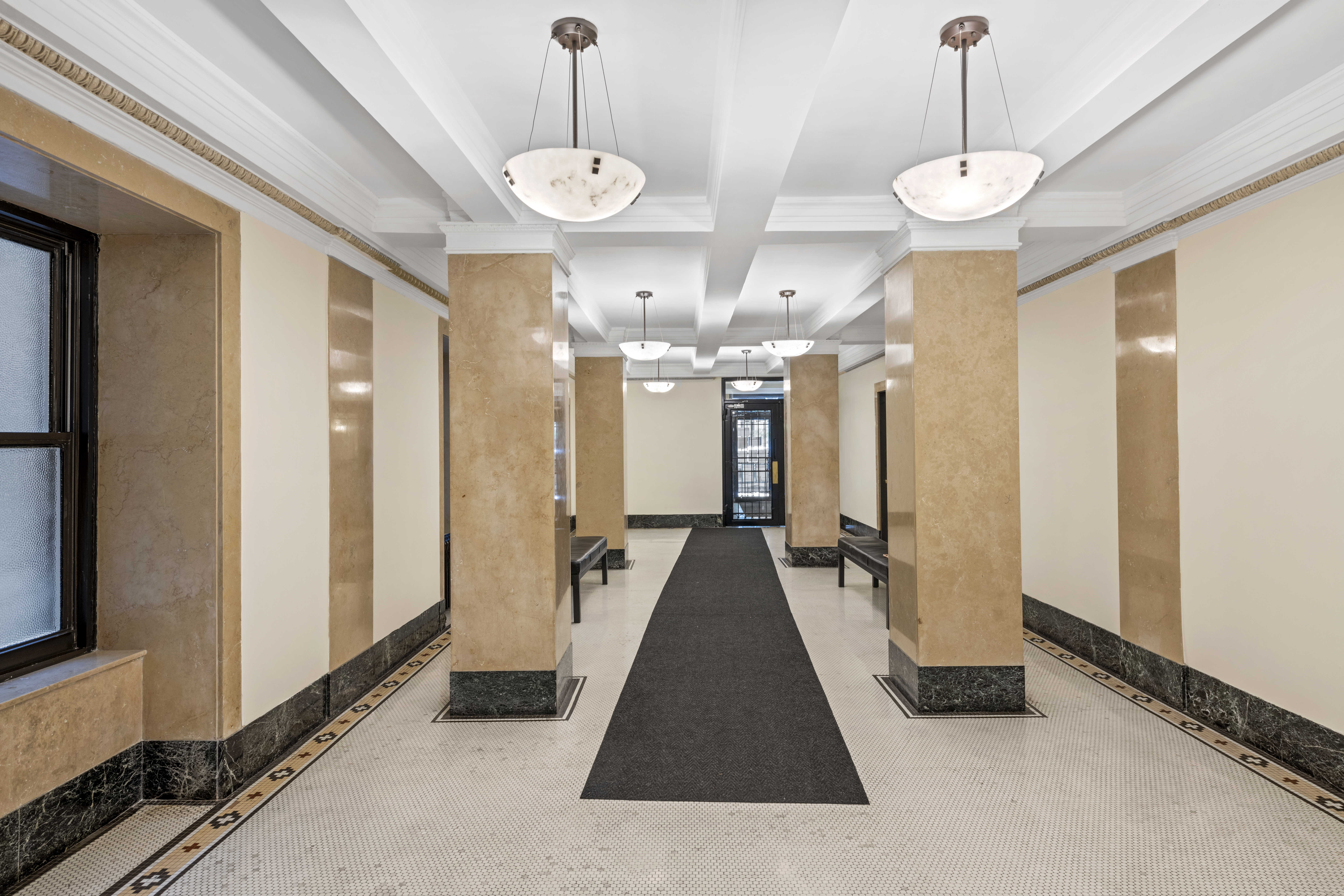 609 West 114th Street, Unit 2 Manhattan, NY 10025 - Photo 14 of 16 a view of a hallway with windows and chandelier