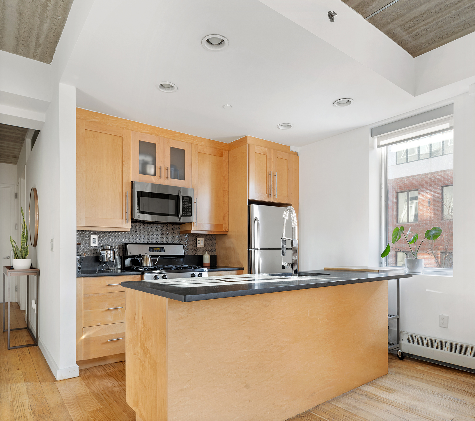 529 Court Street, Unit 204 Brooklyn, NY 11231 - Photo 3 of 9 a kitchen with stainless steel appliances granite countertop a stove a sink and a refrigerator