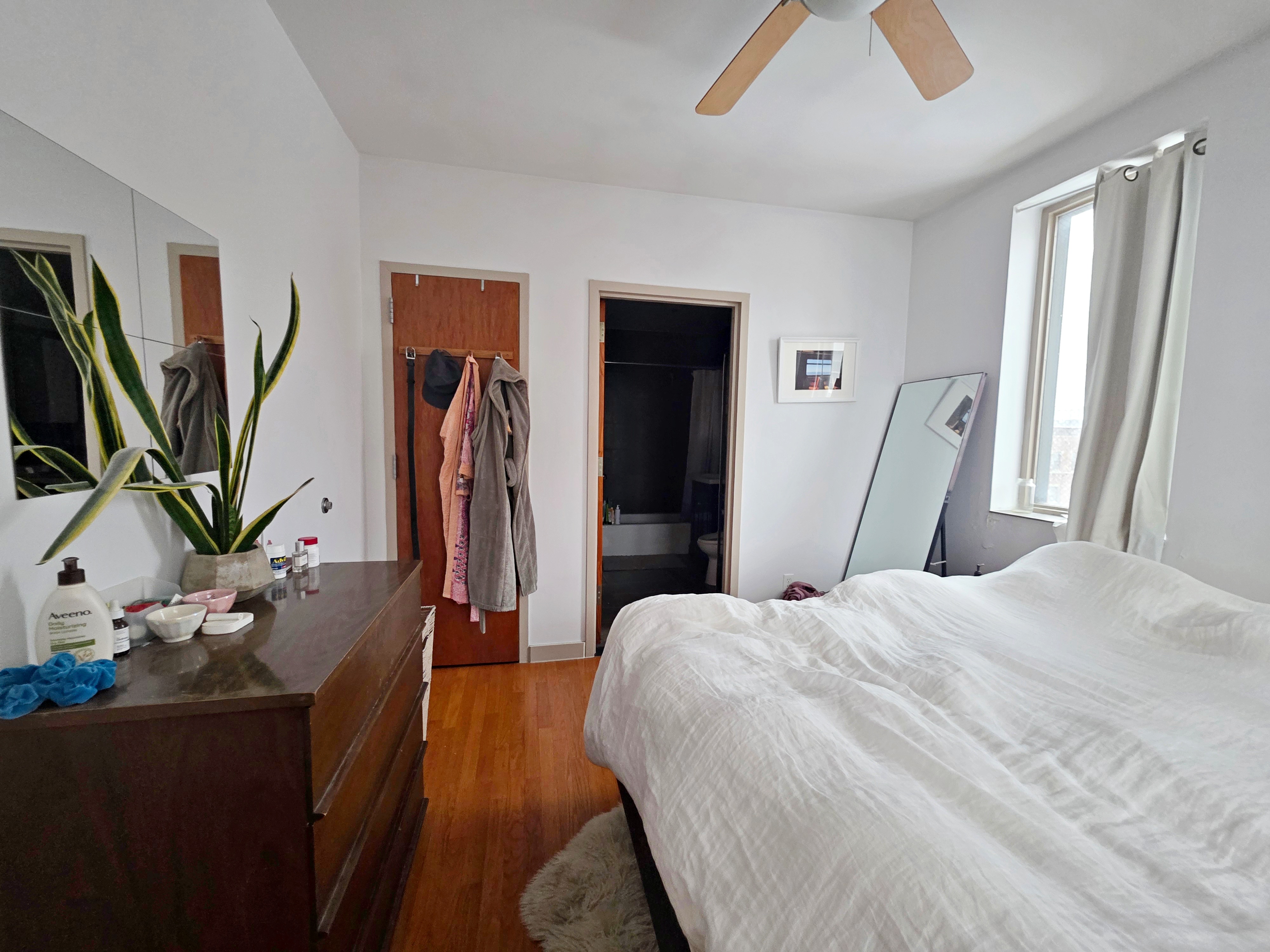 713 Metropolitan Avenue, Unit 4R Brooklyn, NY 11211 - Photo 4 of 11 a bedroom with a large bed and a flat tv screen