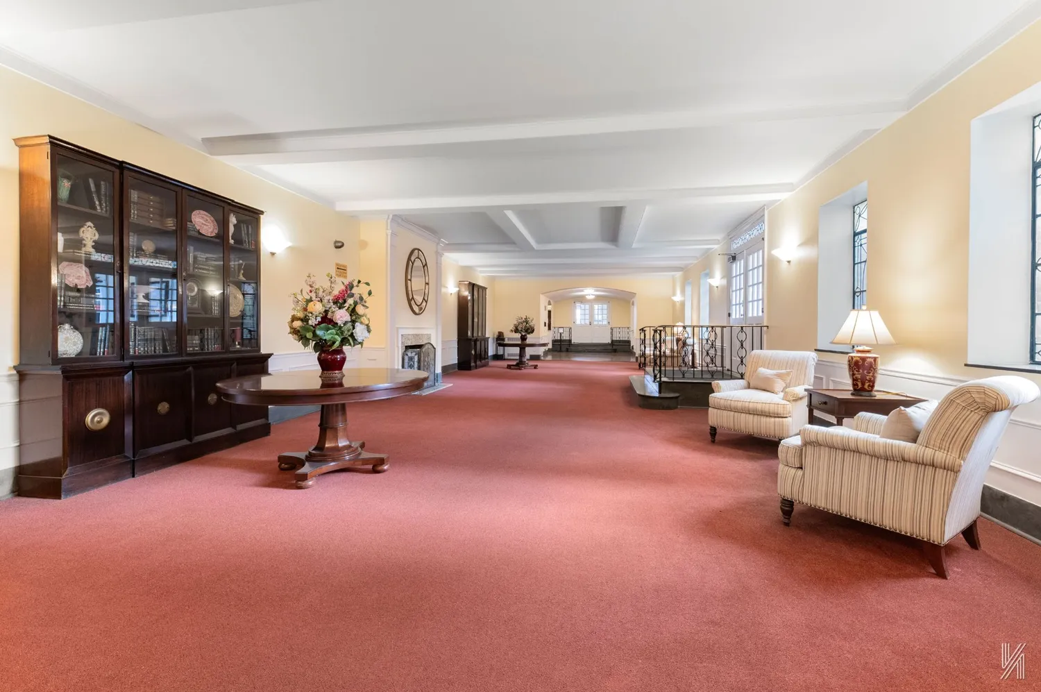 a living room with furniture a flat screen tv and a large window