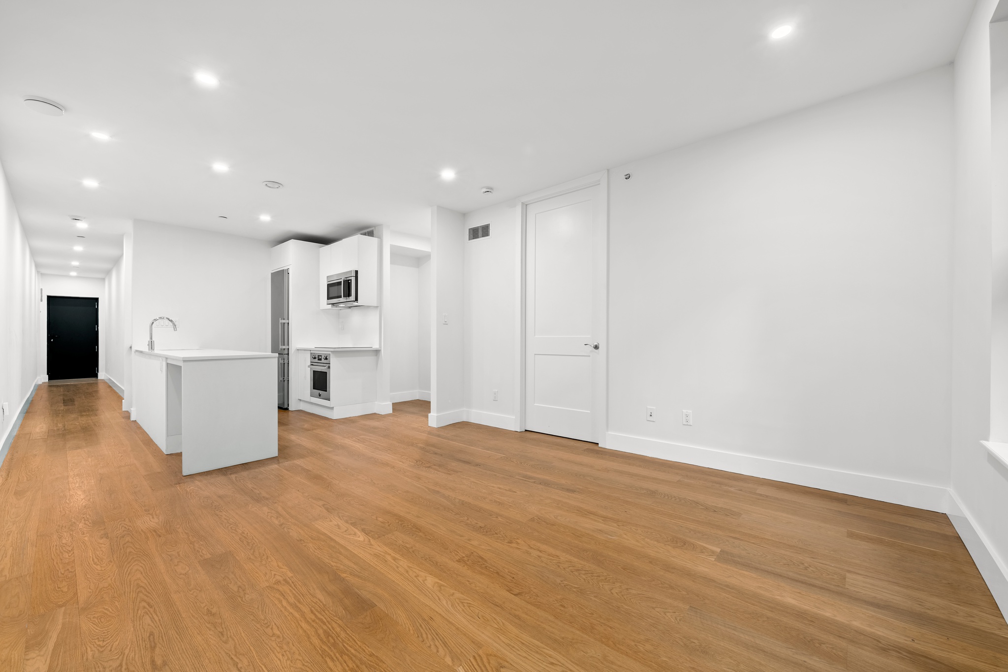 277 Greene Avenue, Unit B Brooklyn, NY 11238 - Photo 3 of 13 a view of kitchen with refrigerator stove and wooden floor