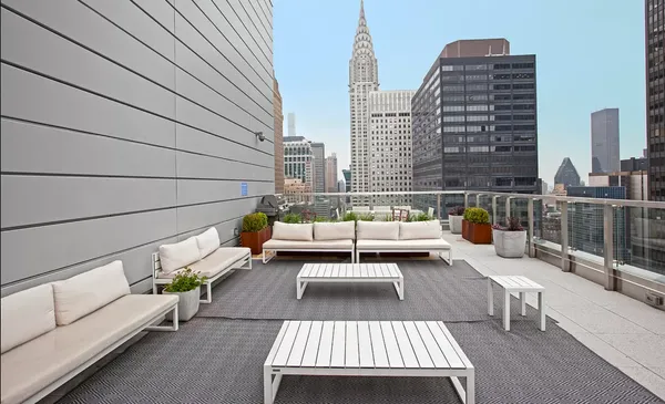 a view of balcony with couch and chairs