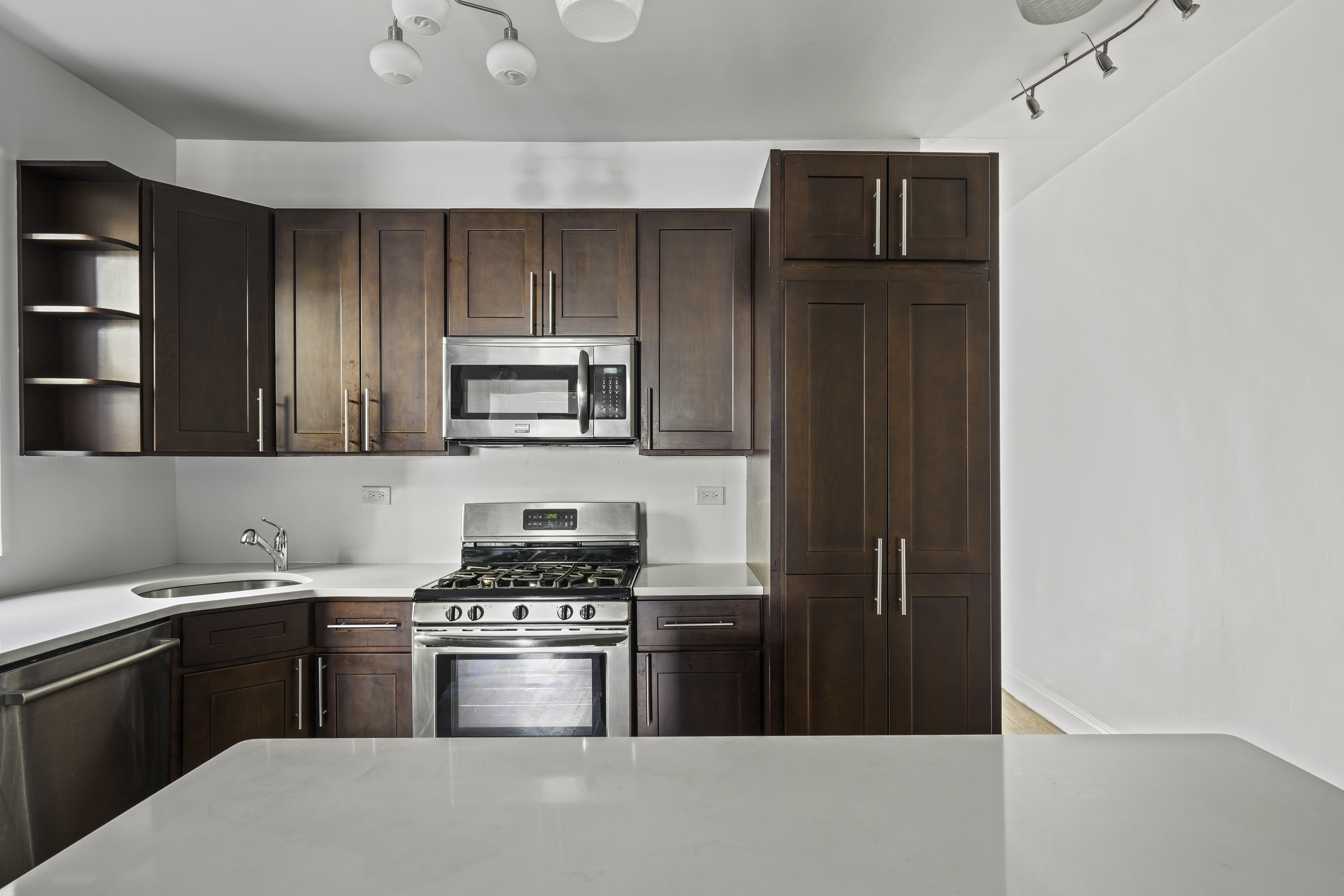 514 86th Street, Unit 4 Brooklyn, NY 11209 - Photo 4 of 19 a kitchen with stainless steel appliances a refrigerator stove and microwave