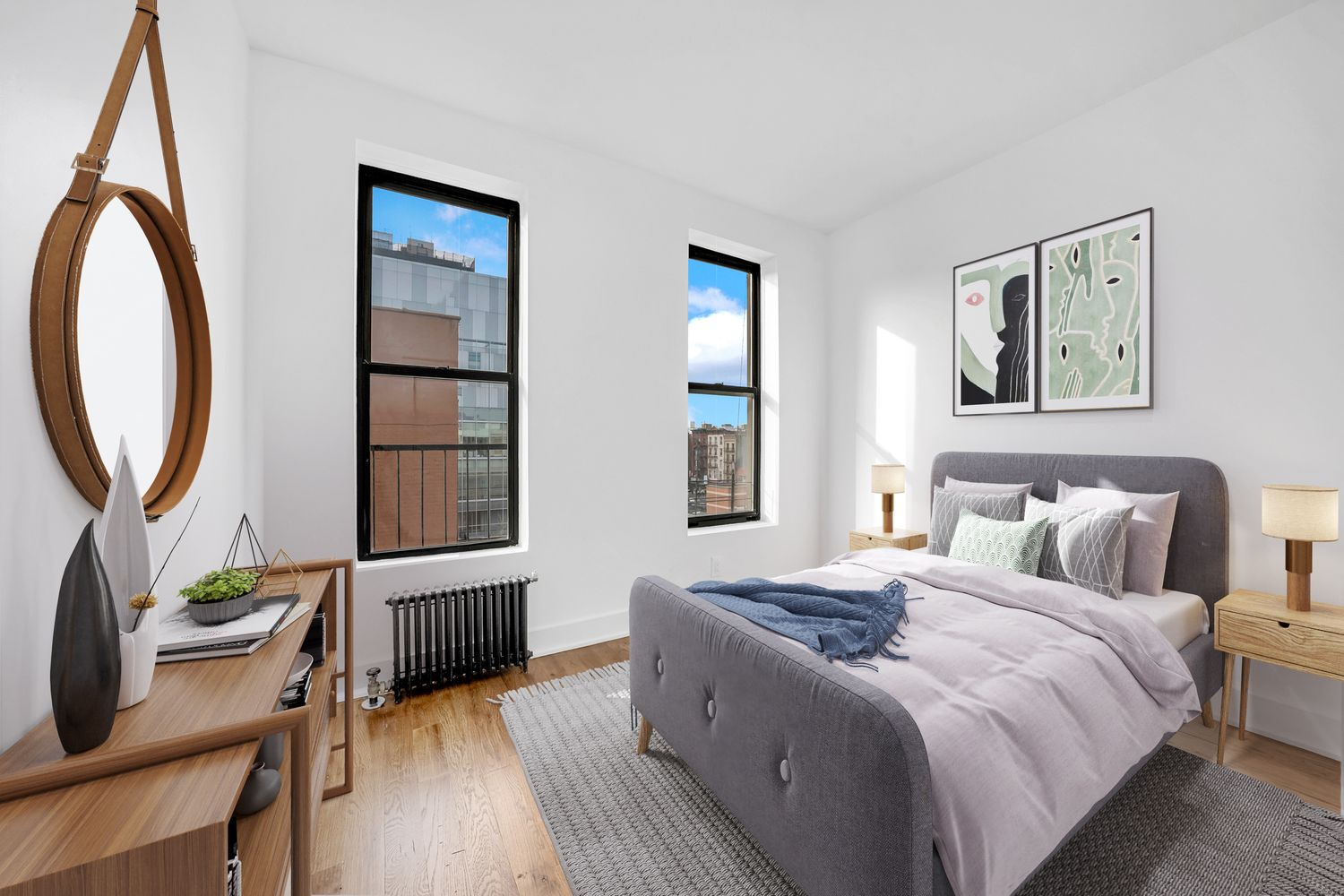 66 West 138th Street, Unit 2D Manhattan, NY 10037 - Photo 3 of 5 a bedroom with a bed a mirror and a potted plant with wooden floor