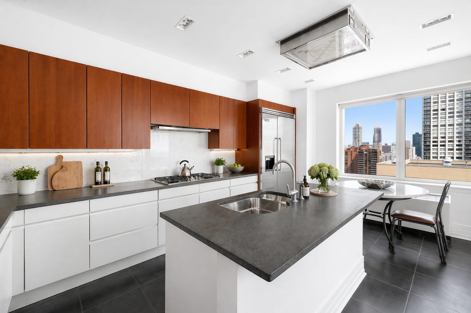 300 East 55th Street, Unit PHC Manhattan, NY 10022 - Photo 12 of 23 a kitchen with a dining table chairs and white cabinets