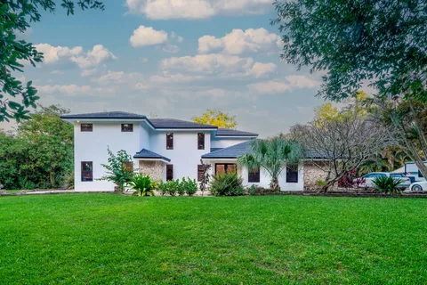 a front view of house with yard and green space