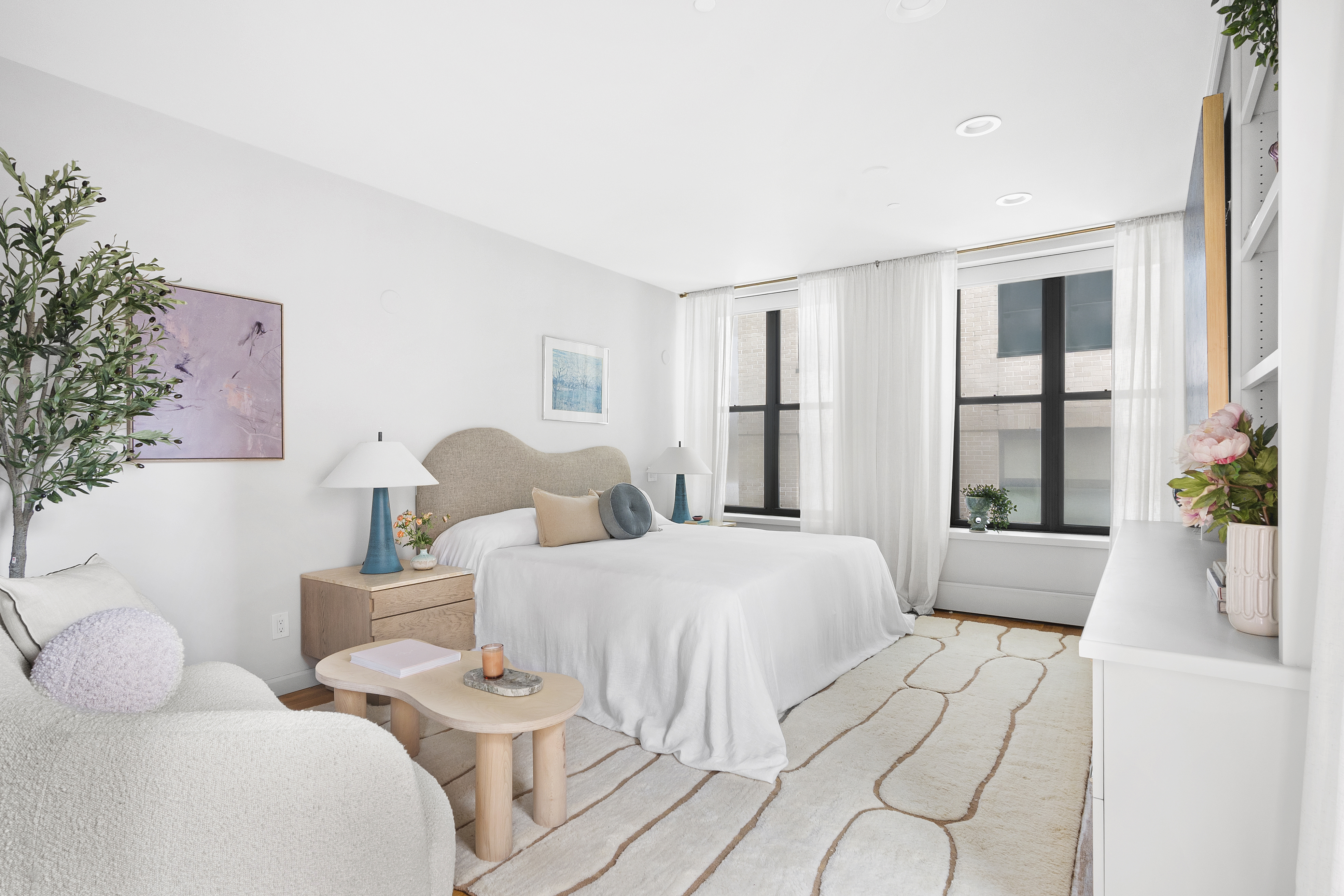 120 West 20th Street, Unit PH Manhattan, NY 10011 - Photo 7 of 15 a spacious bedroom with two beds and large window with potted plants