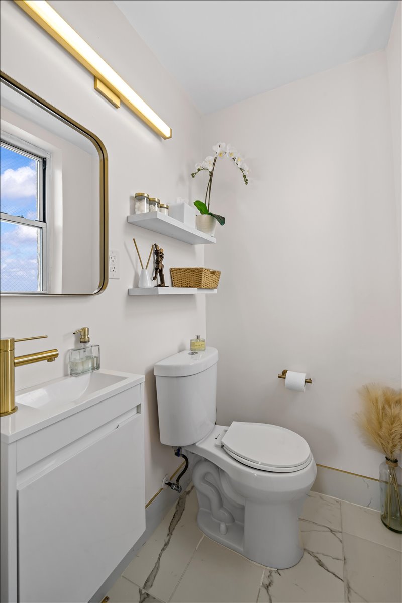 759 East 10th Street, Unit 7H Brooklyn, NY 11230 - Photo 9 of 15 a white toilet sitting next to a bathroom sink