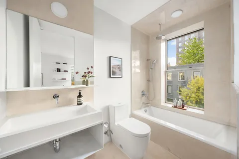 a bathroom with a sink a toilet and a bathtub