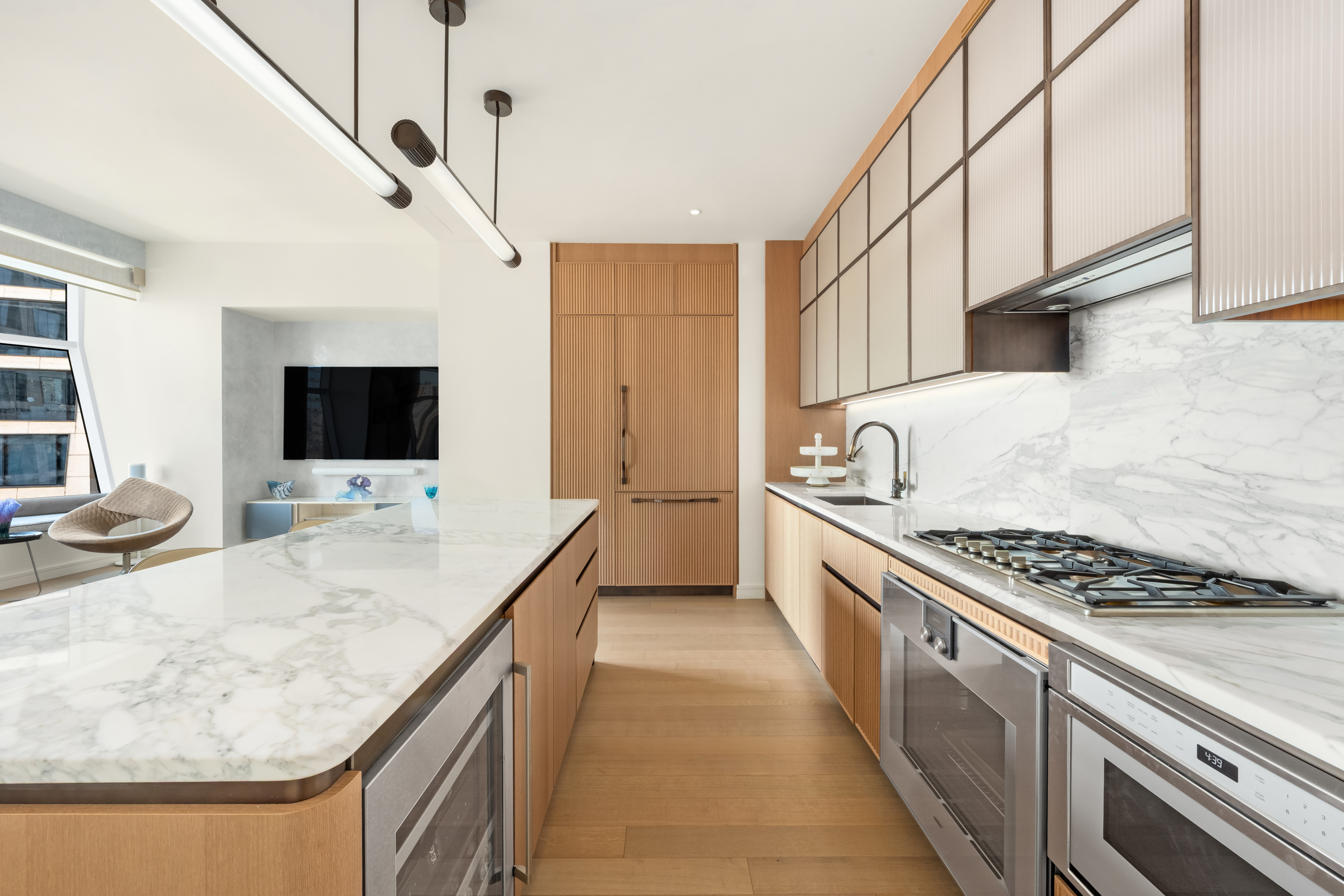 515 West 18th Street, Unit 1403 Manhattan, NY 10011 - Photo 3 of 21 a kitchen with stainless steel appliances granite countertop a sink stove and refrigerator