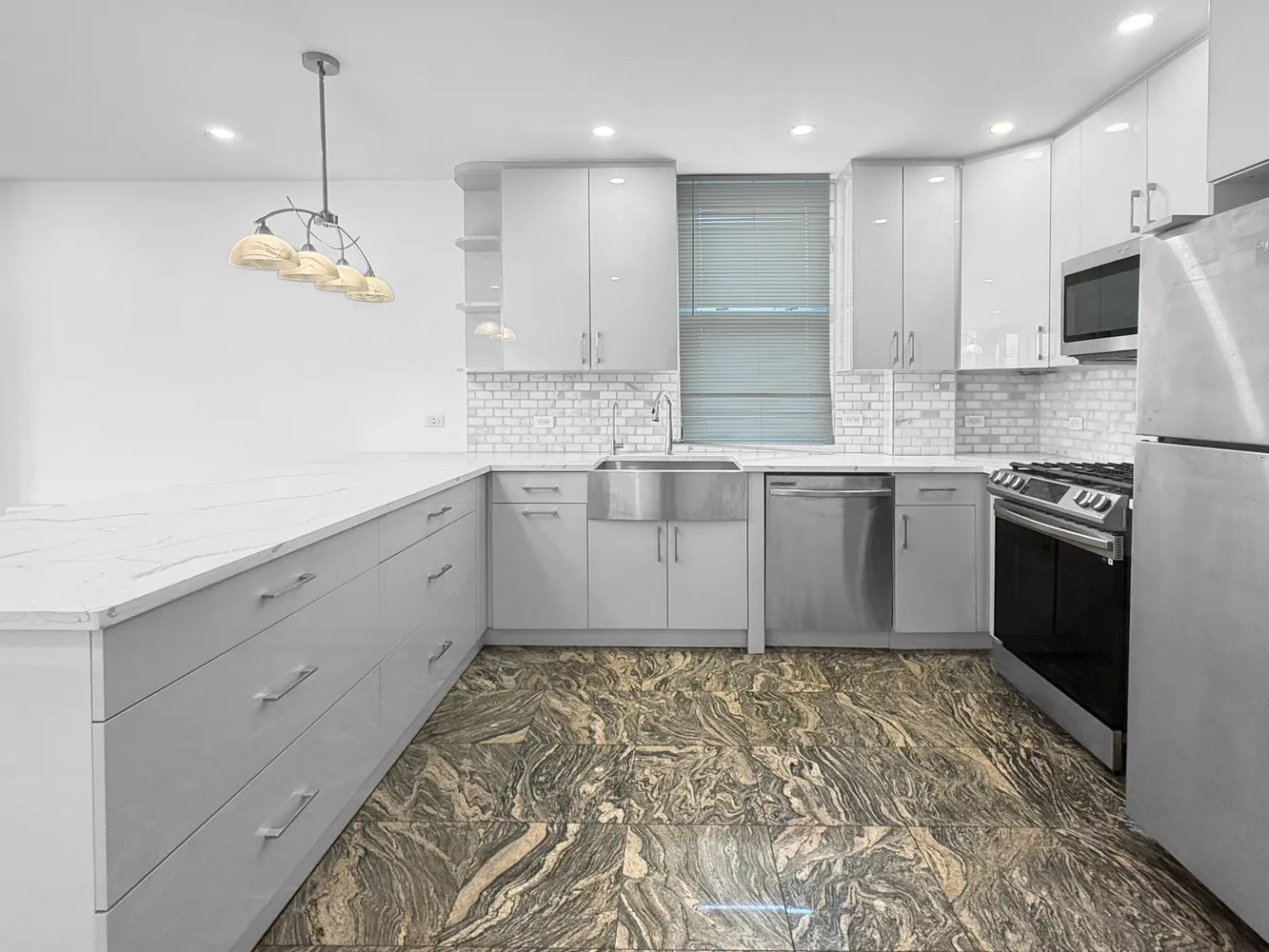 a kitchen with stainless steel appliances granite countertop a sink stove and refrigerator
